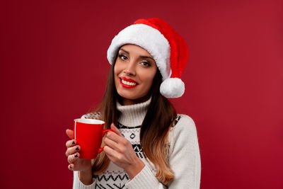 Portrait of a young woman drinking coffee