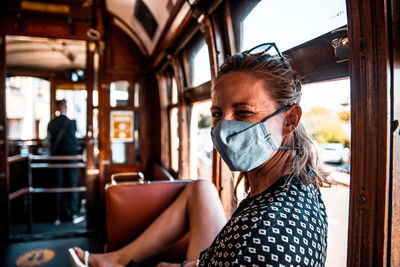 Female wearing mouth and nose mask in public transportation covid-19 regulations