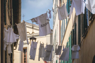 Low angle view of clothes drying against buildings