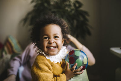 Smiling girl holding colorful ball