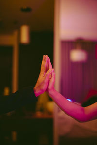 Cropped hand of woman holding illuminated lighting equipment