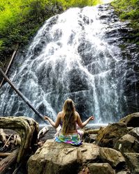 Woman sitting on rock