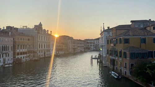 View of buildings in city at sunset