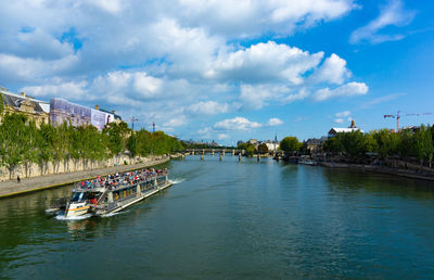 Scenic view of river against sky in city