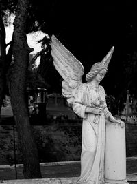 Statue of angel against sky