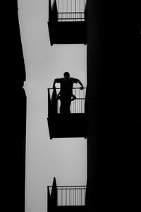 Low angle view of silhouette person against window