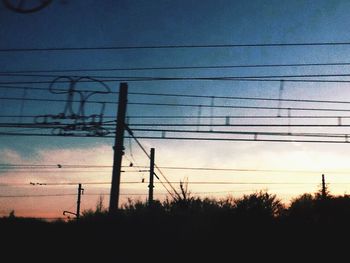 Low angle view of electricity pylon against sky