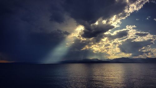 Scenic view of sea against storm clouds