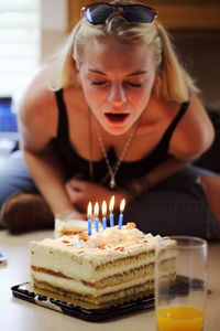 Woman blowing birthday candles