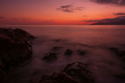 Scenic view of sea against romantic sky at sunset