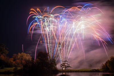 Low angle view of firework display at night