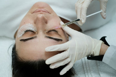 Top view of female patient having eye mesotheraphy applied