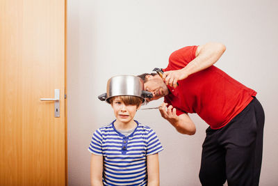 Father and son standing on floor