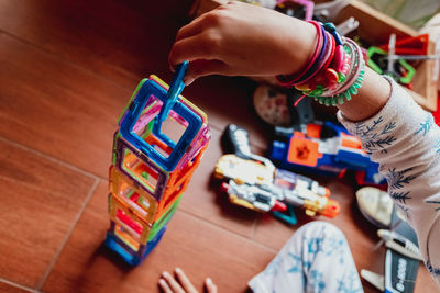 High angle view of girl playing with toy at home