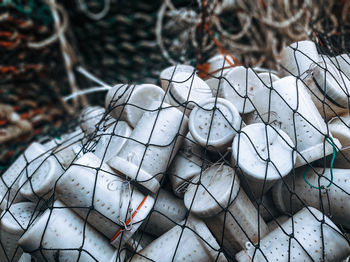 View of plastic containers in net outdoors