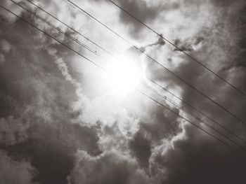 Low angle view of power lines against sky