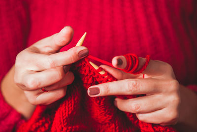 Close-up of woman holding red hands