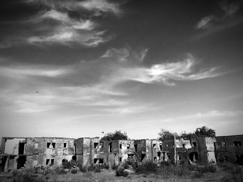 Buildings against cloudy sky