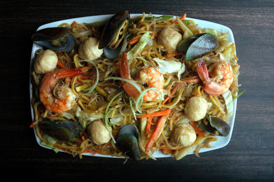 High angle view of seafood pancit noodles in plate on table