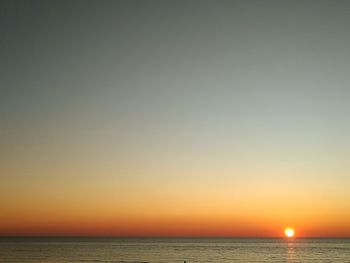 Scenic view of sea against clear sky during sunset