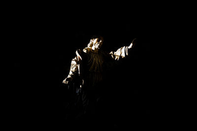 Statue against black sky at night