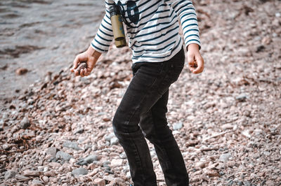 Low section of man standing on rock