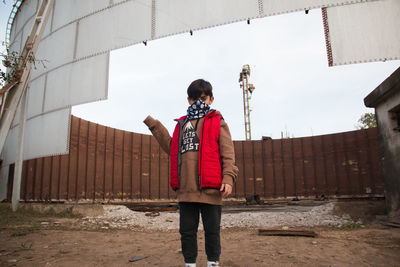 Street portrait of child wearing face mask and winter clothing