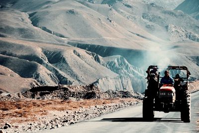 People on road against mountain range