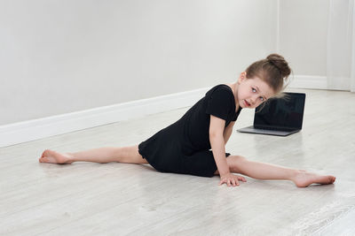 Girl looking away while doing split at home