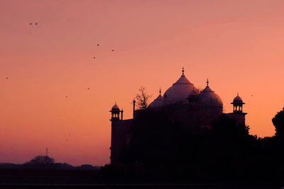 Low angle view of mosque against sky during sunset