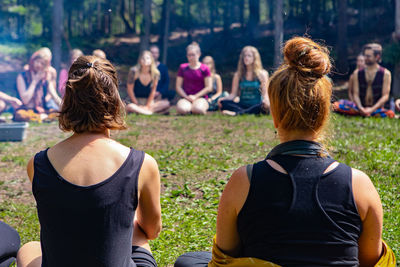 Rear view of people sitting in park