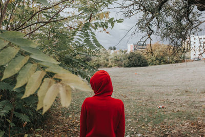 Rear view of woman against trees