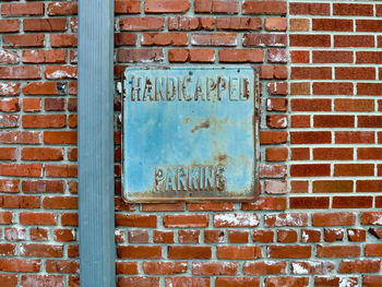 Close-up of text on brick wall