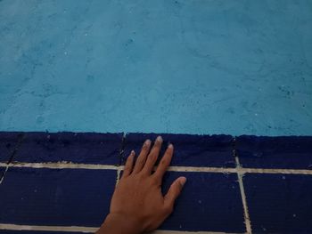 Low section of person against swimming pool