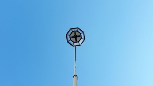 Low angle view of lamp against blue sky