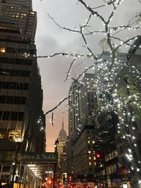 Illuminated city against sky at night