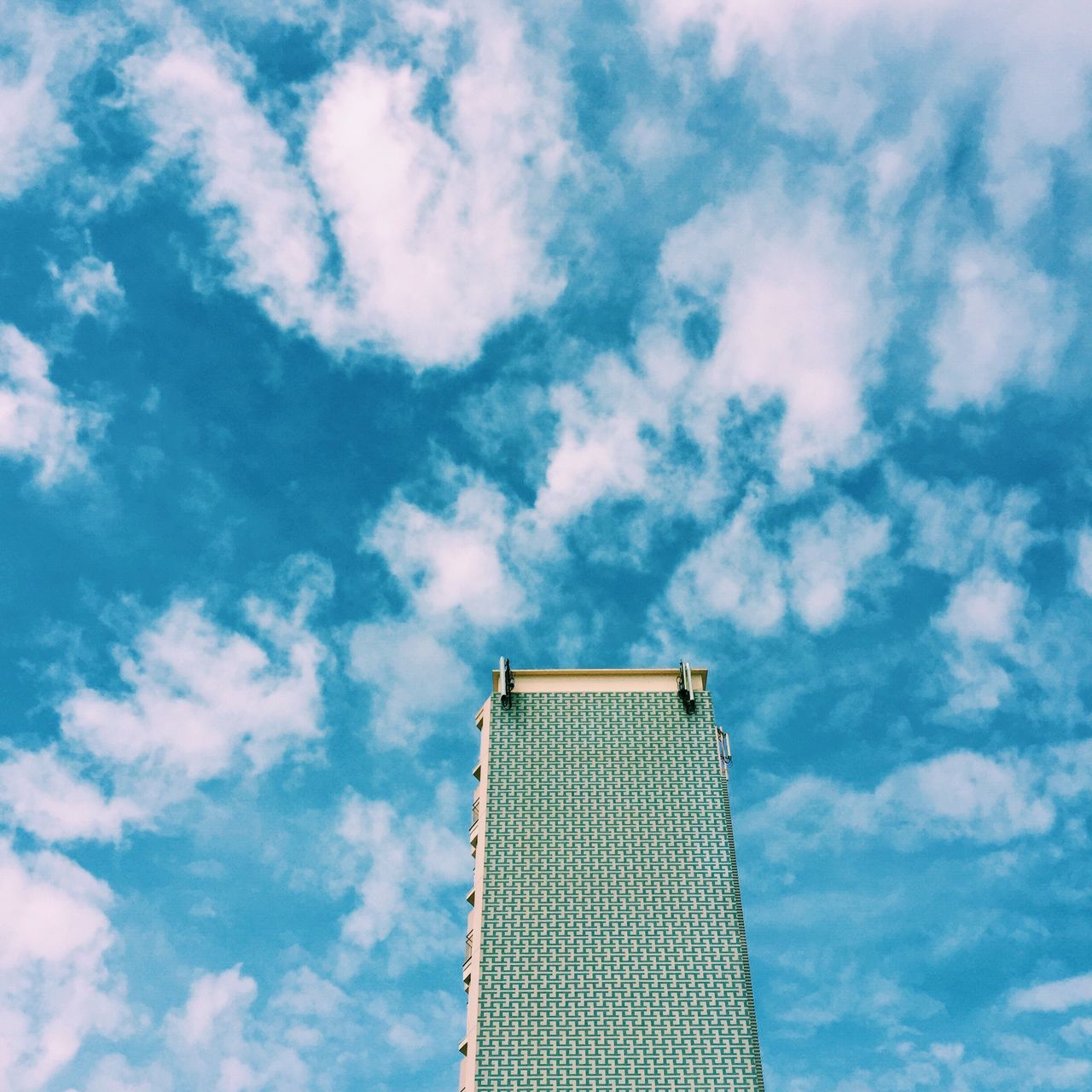 low angle view, architecture, building exterior, sky, built structure, modern, cloud - sky, tall - high, skyscraper, office building, city, tower, cloud, blue, cloudy, building, day, outdoors, directly below, no people