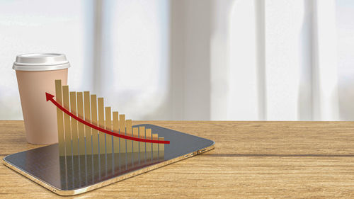 Close-up of wooden table against wall at home