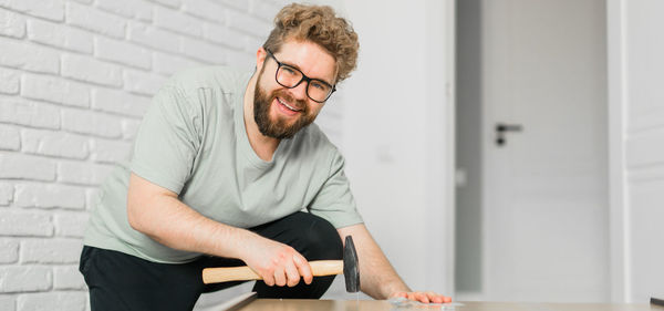 Young man using mobile phone while sitting at home