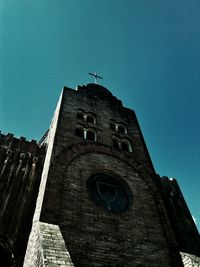 Low angle view of historic building against clear blue sky