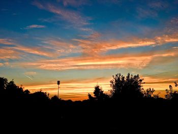 Silhouette of trees against sky at sunset