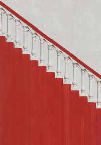 View of staircase against red wall