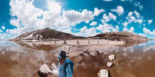 Side view of a man with woman in mountains against sky