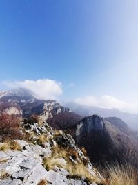 Scenic view of snowcapped mountains against blue sky