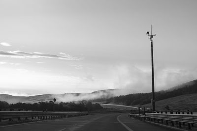 Empty road against cloudy sky