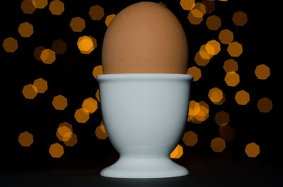 Close-up of tea cup against black background