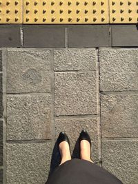 Low section of woman standing on tiled floor