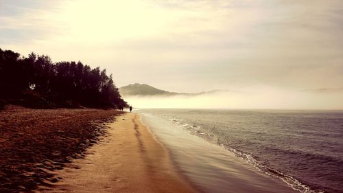 Scenic view of sea against cloudy sky