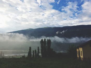 Scenic view of mountains against cloudy sky