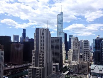 Skyscrapers against cloudy sky